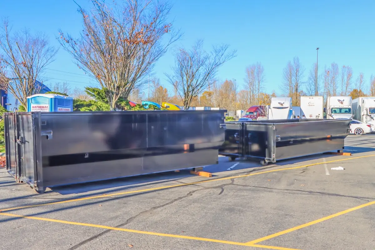 Professional dumpster rental service with roll-off container on residential driveway in Viera East